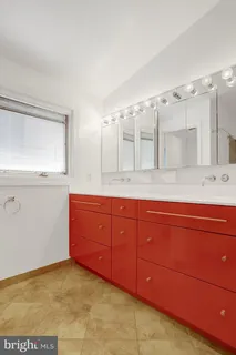 a bathroom with a sink and a large mirror