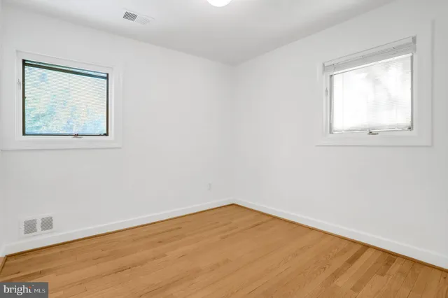 a view of a house with a big yard and large trees