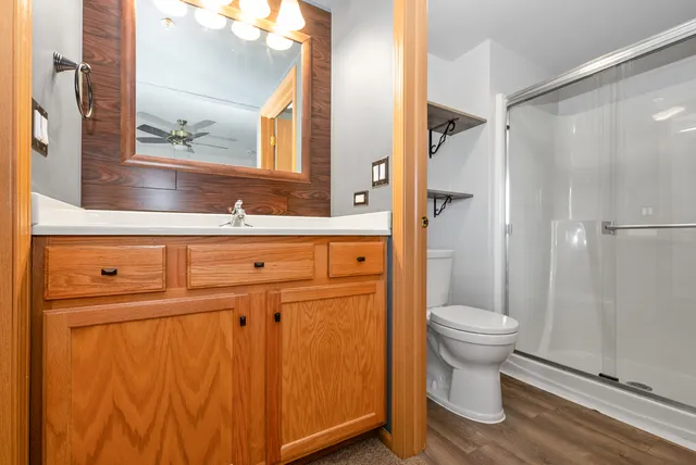 a bathroom with a toilet a sink and a mirror