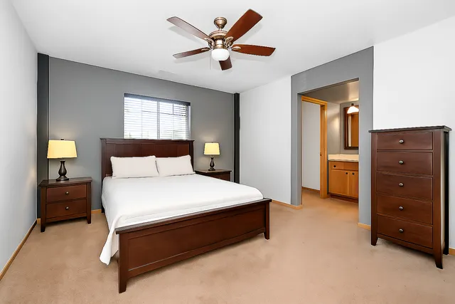 a bedroom with a bed and a tv on a dresser