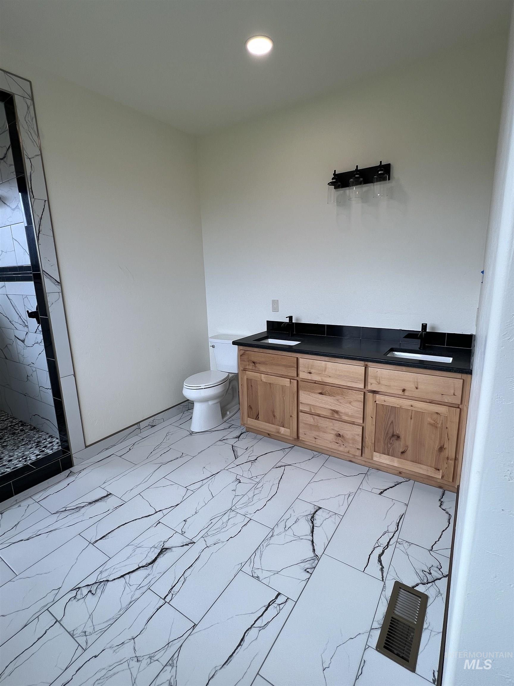 137 Angus Ranch Grangeville, ID 83530 - Photo 20 of 32 Bathroom featuring a marble finish shower, light marble finish floors, double vanity, and recessed lighting