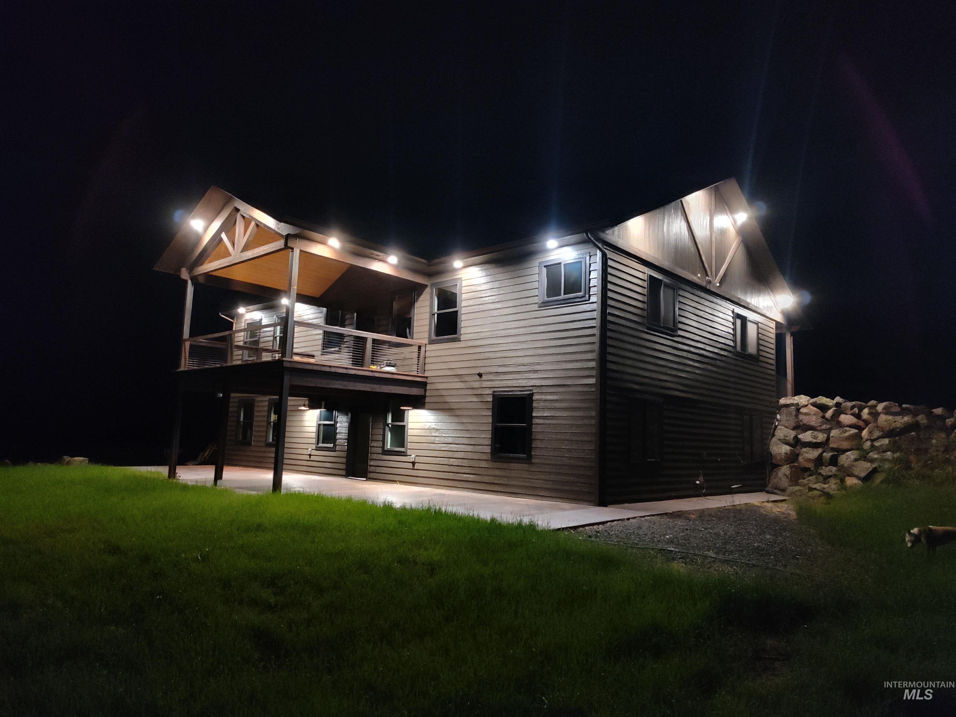 137 Angus Ranch Grangeville, ID 83530 - Photo 31 of 32 Back of house at twilight with a patio area and a lawn
