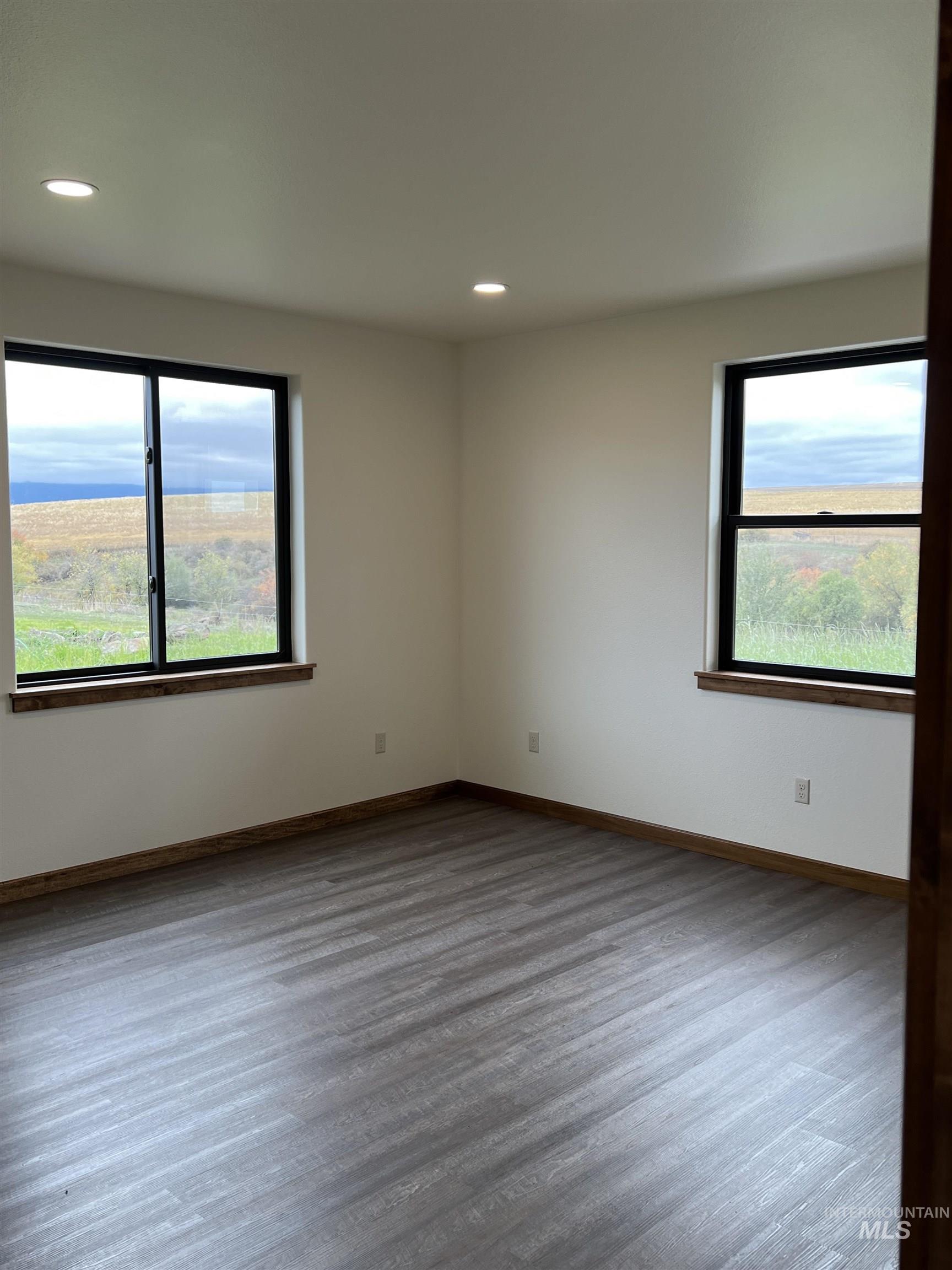 137 Angus Ranch Grangeville, ID 83530 - Photo 4 of 32 Unfurnished room featuring wood finished floors, healthy amount of natural light, and recessed lighting
