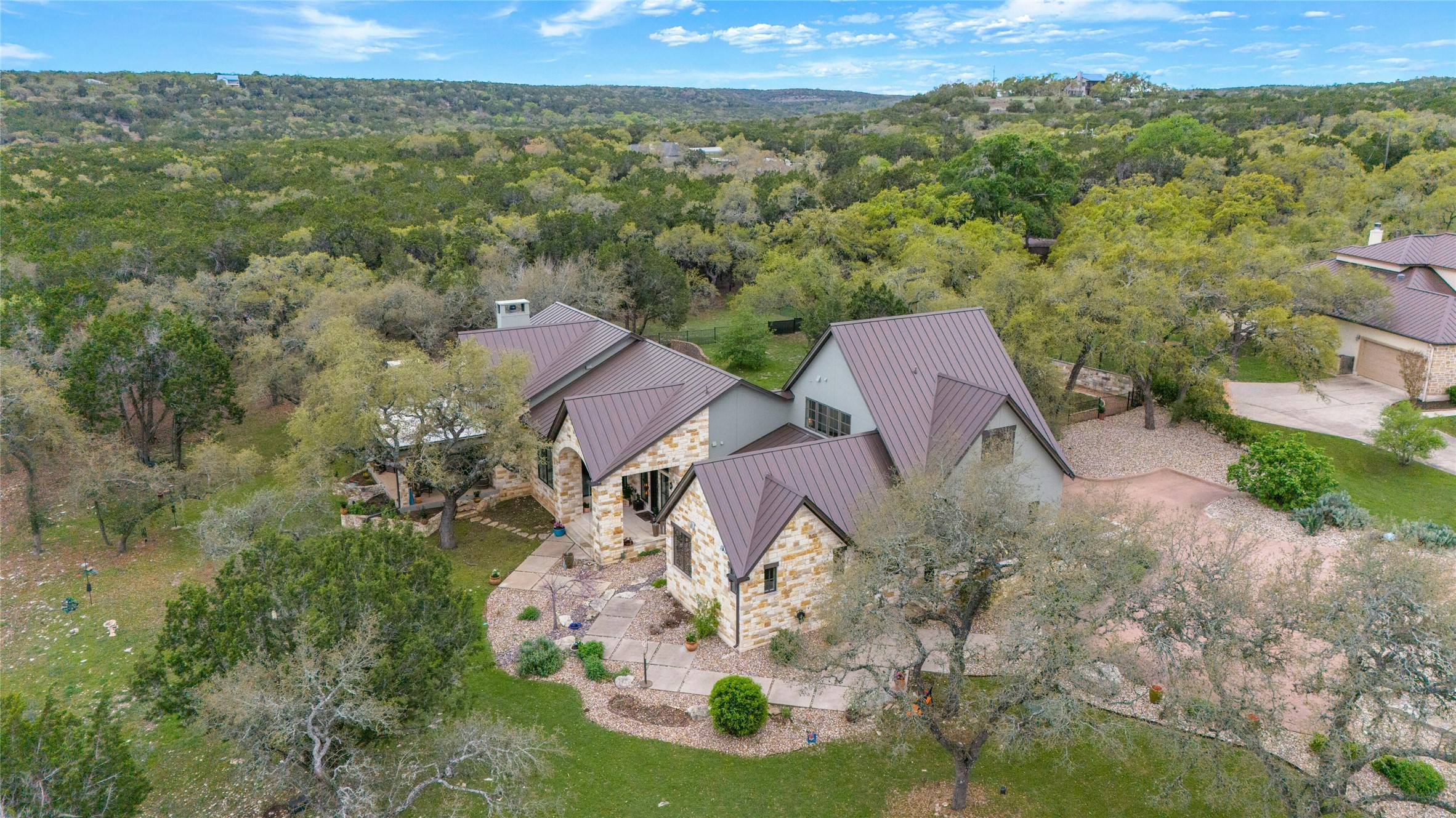 an aerial view of residential houses with outdoor space and trees