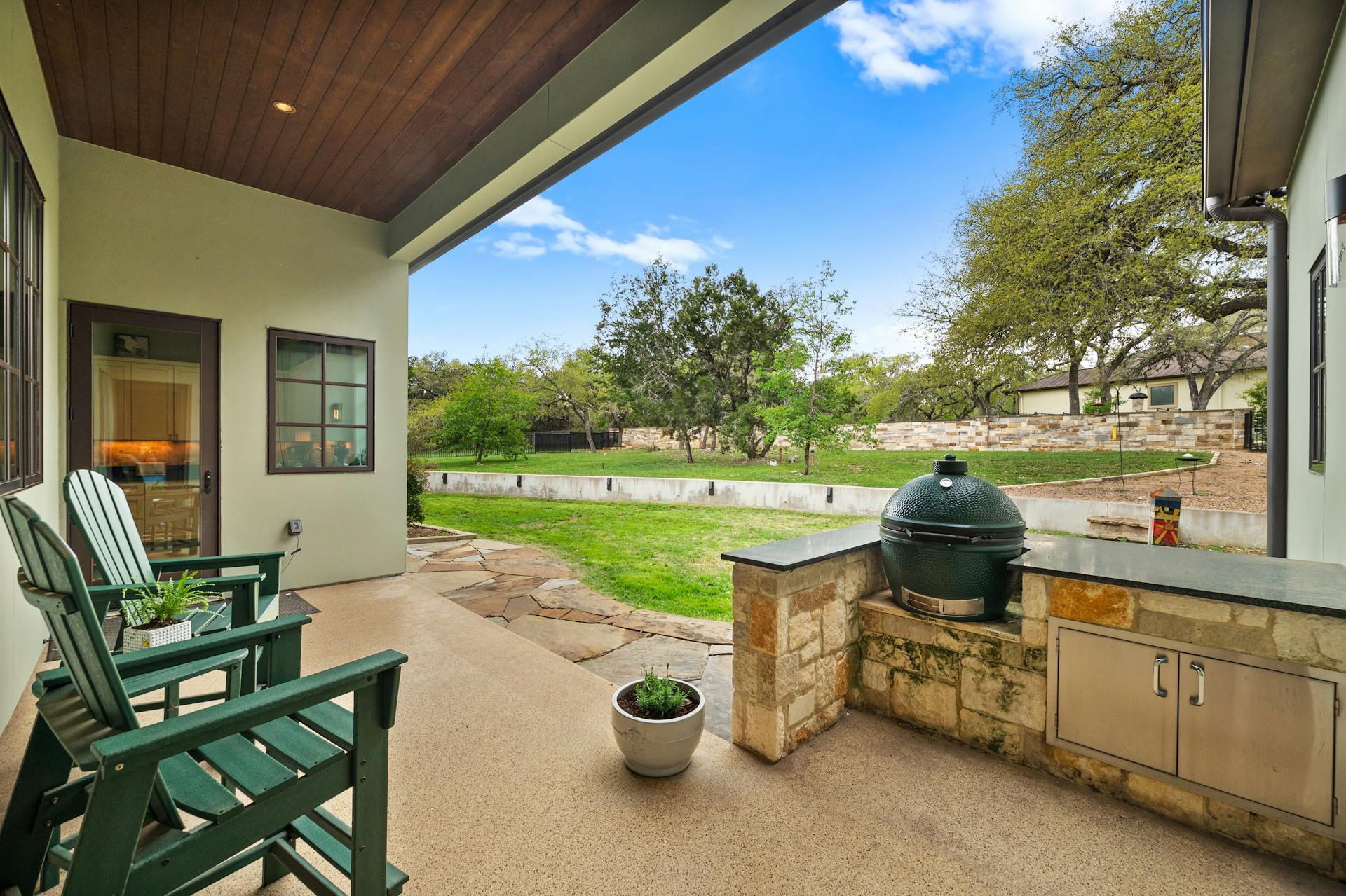 1330 Ranchers Club Lane Driftwood, TX 78619 - Photo 37 of 40 a view of a patio with table and chairs potted plants with wooden floor and fence