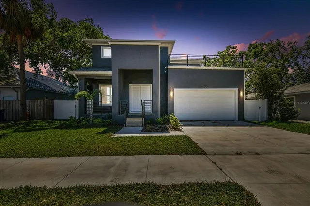 a front view of a house with a yard and a garage