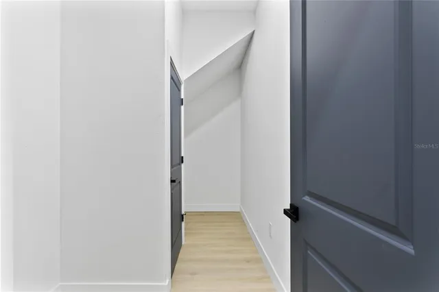 a bathroom with a sink a toilet a mirror and shower