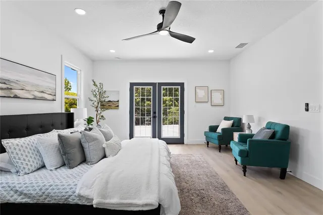 a spacious bedroom with a bed a couch and a window