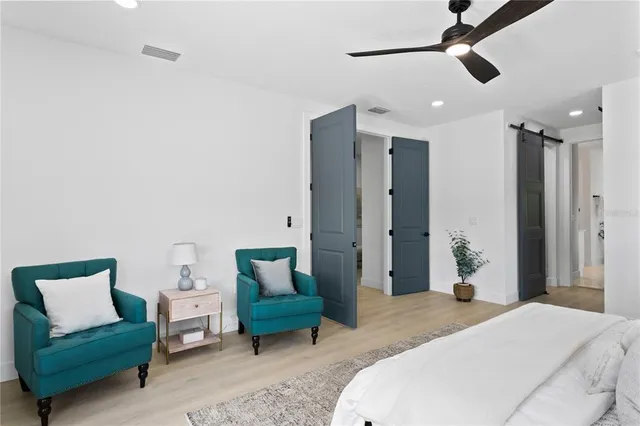 a bedroom with a bed a couch and a window