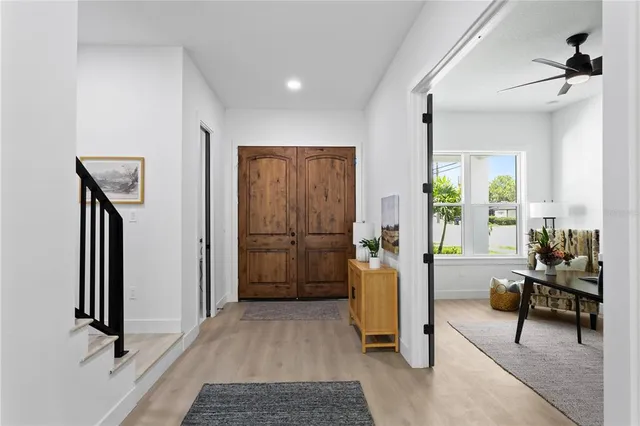a view of entryway and hall with wooden floor
