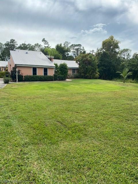 6560 Bottlebrush Lane Naples, FL 34109 - Photo 2 of 4 a front view of a house with a garden