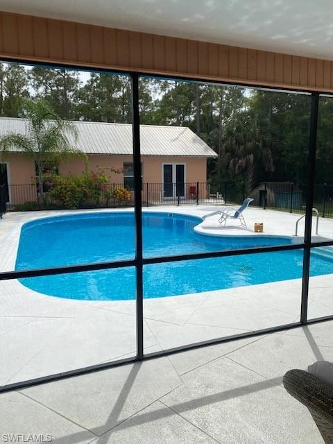 6560 Bottlebrush Lane Naples, FL 34109 - Photo 3 of 4 a view of a balcony with floor to ceiling window next to a yard