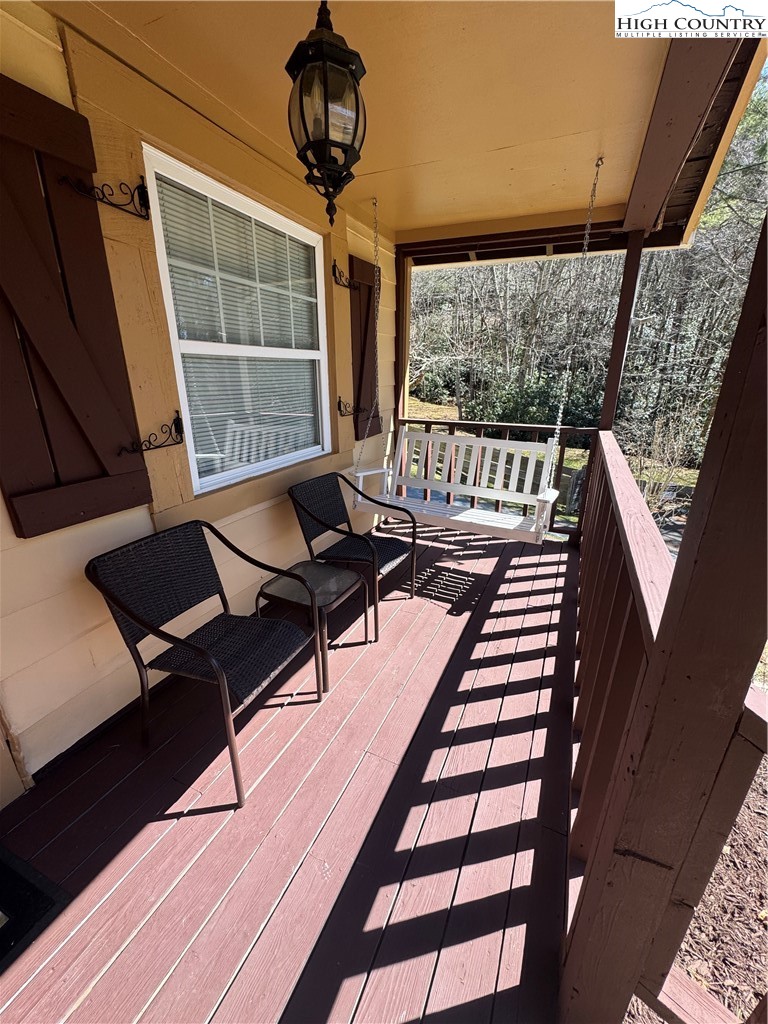 84 Avery High School Road Newland, NC 28657 - Photo 17 of 29 a balcony with wooden floor outdoor seating and stairs