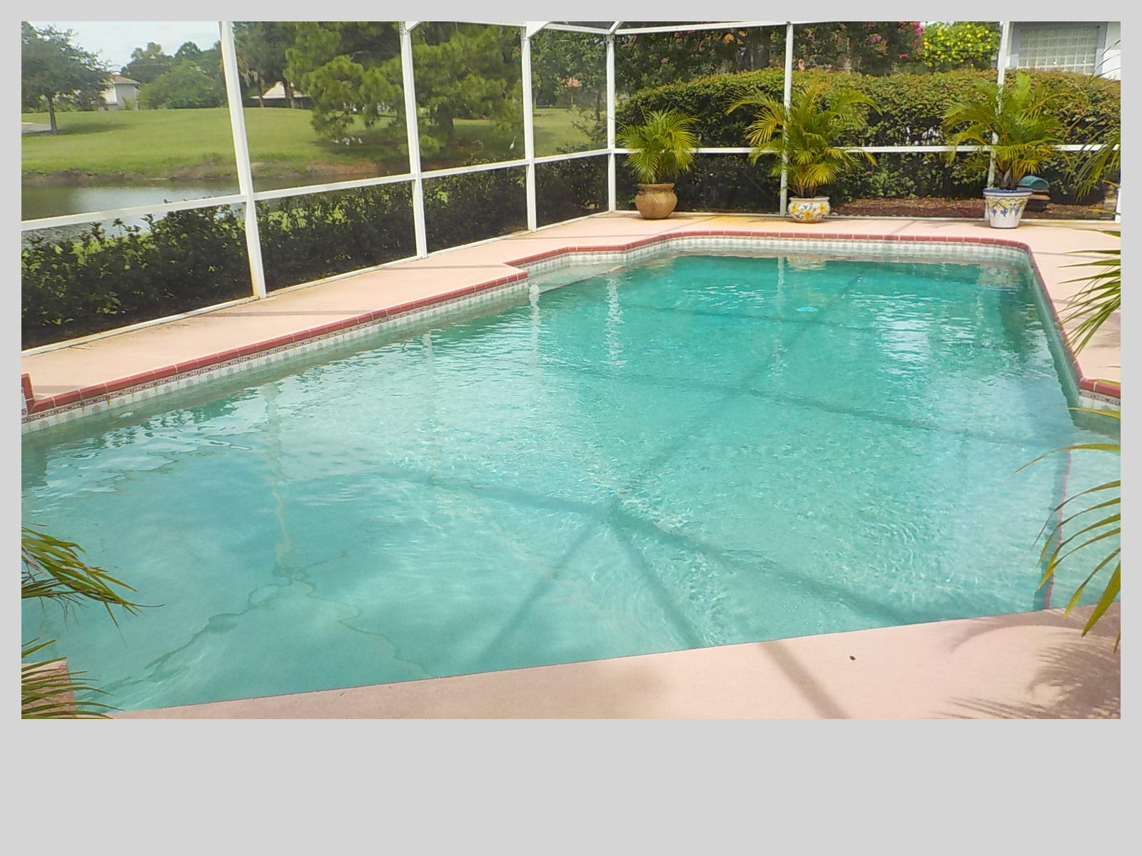 2159 Southeast Erwin Road Port St. Lucie, FL 34952 - Photo 33 of 48 a view of a swimming pool with a yard and sitting area