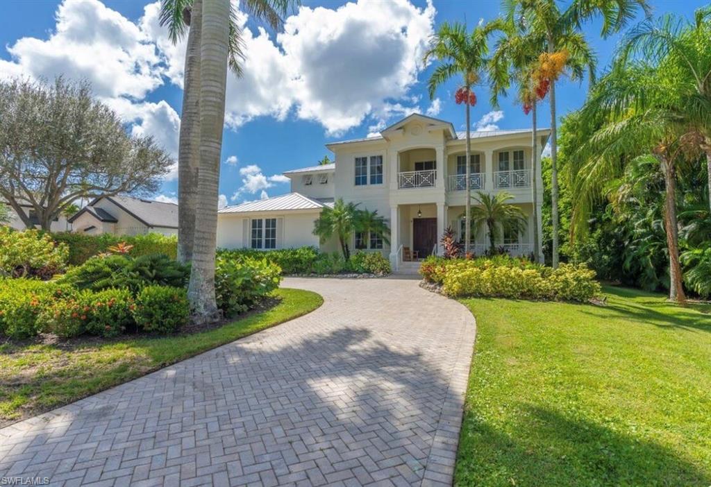 Mediterranean / spanish-style house featuring decorative driveway, stucco siding, and a front yard