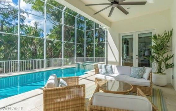 428 Rudder Road Naples, FL 34102 - Photo 21 of 49 a view of a patio with couches chairs and floor to ceiling window