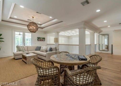 428 Rudder Road Naples, FL 34102 - Photo 33 of 49 a living room with furniture a clock and a large window