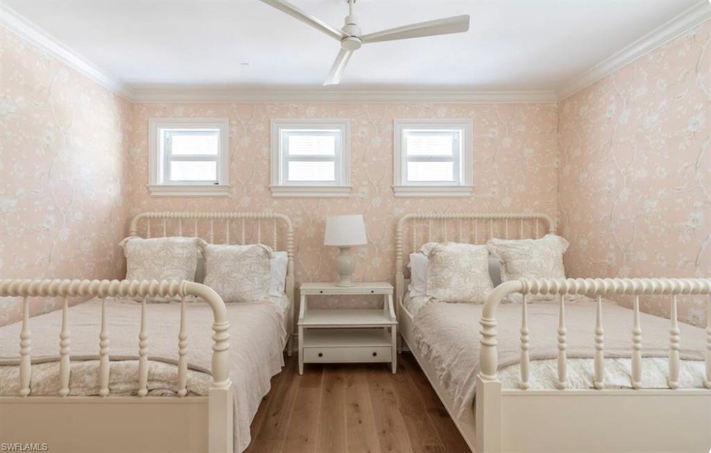 428 Rudder Road Naples, FL 34102 - Photo 37 of 49 a large white bed sitting in a bedroom next to a window