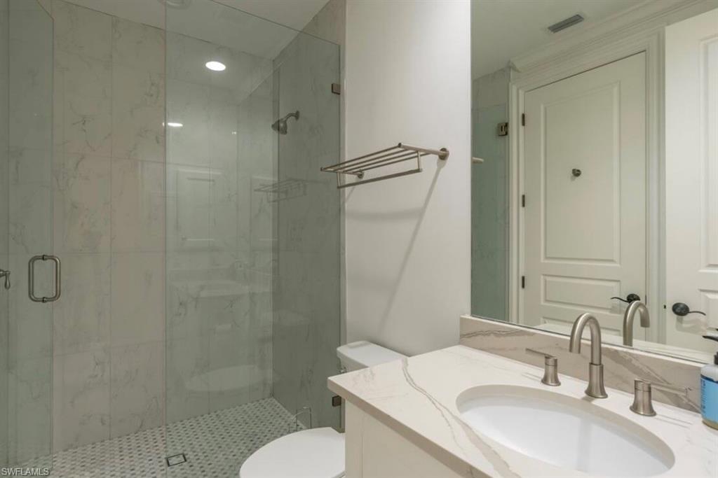 428 Rudder Road Naples, FL 34102 - Photo 44 of 49 a bathroom with a sink toilet and shower