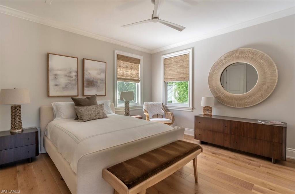 428 Rudder Road Naples, FL 34102 - Photo 45 of 49 a bedroom with a large bed and a large window