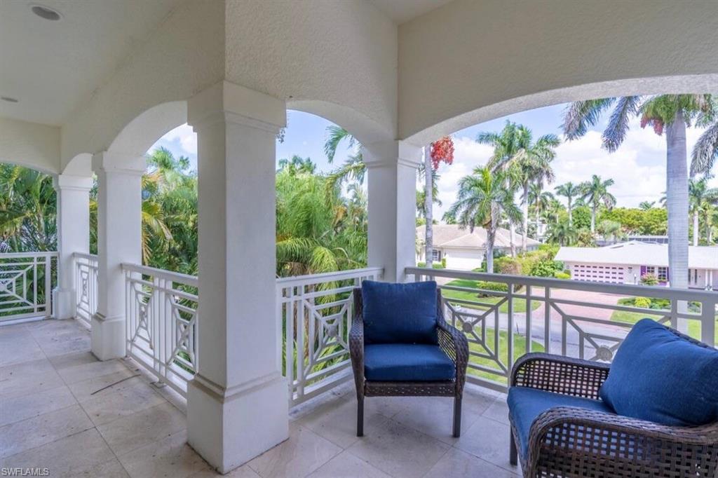428 Rudder Road Naples, FL 34102 - Photo 47 of 49 a balcony with furniture and a potted plant