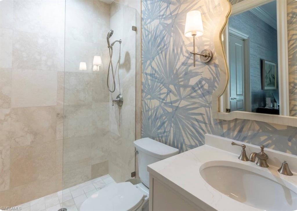428 Rudder Road Naples, FL 34102 - Photo 7 of 49 a bathroom with a sink toilet and shower