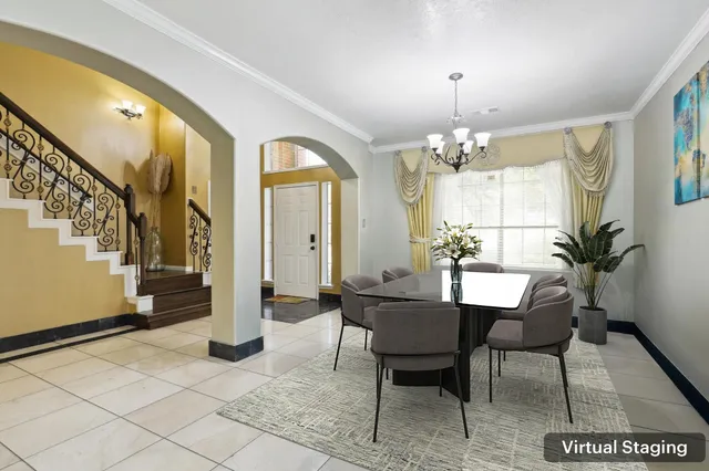 a view of a dining room with furniture and a chandelier