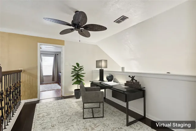 a living room with furniture and a ceiling fan