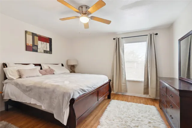 a spacious bedroom with a bed and a dresser