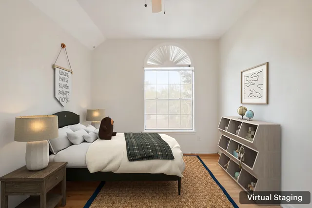 a bedroom with a bed and a window