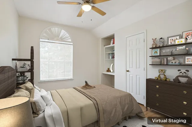 a bedroom with a bed and a window