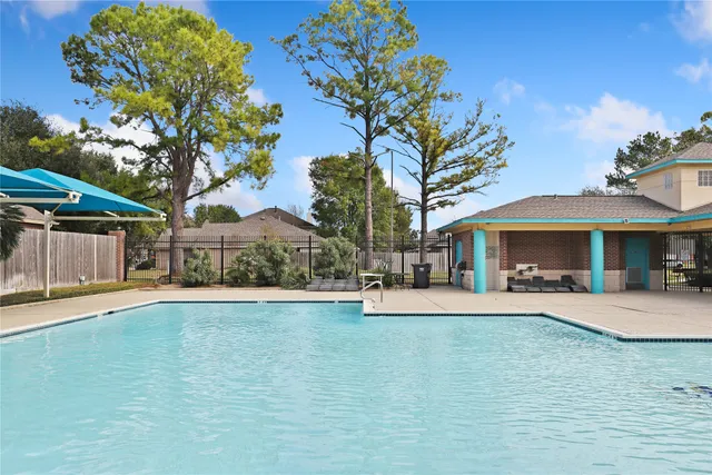 a view of a house with pool and sitting area