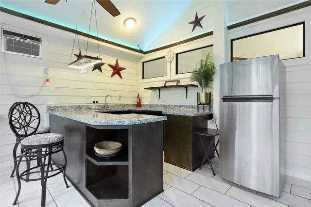 a kitchen with stainless steel appliances granite countertop a refrigerator and a stove