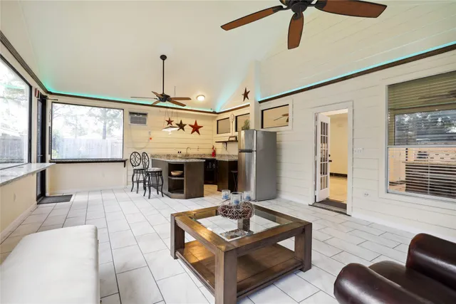 a living room with furniture a chandelier and a flat screen tv