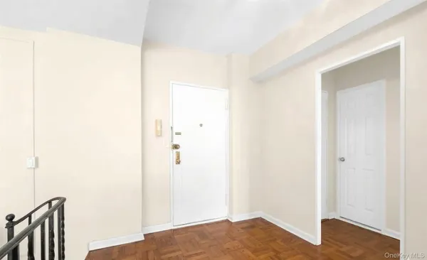 a view of an empty room and wooden floor