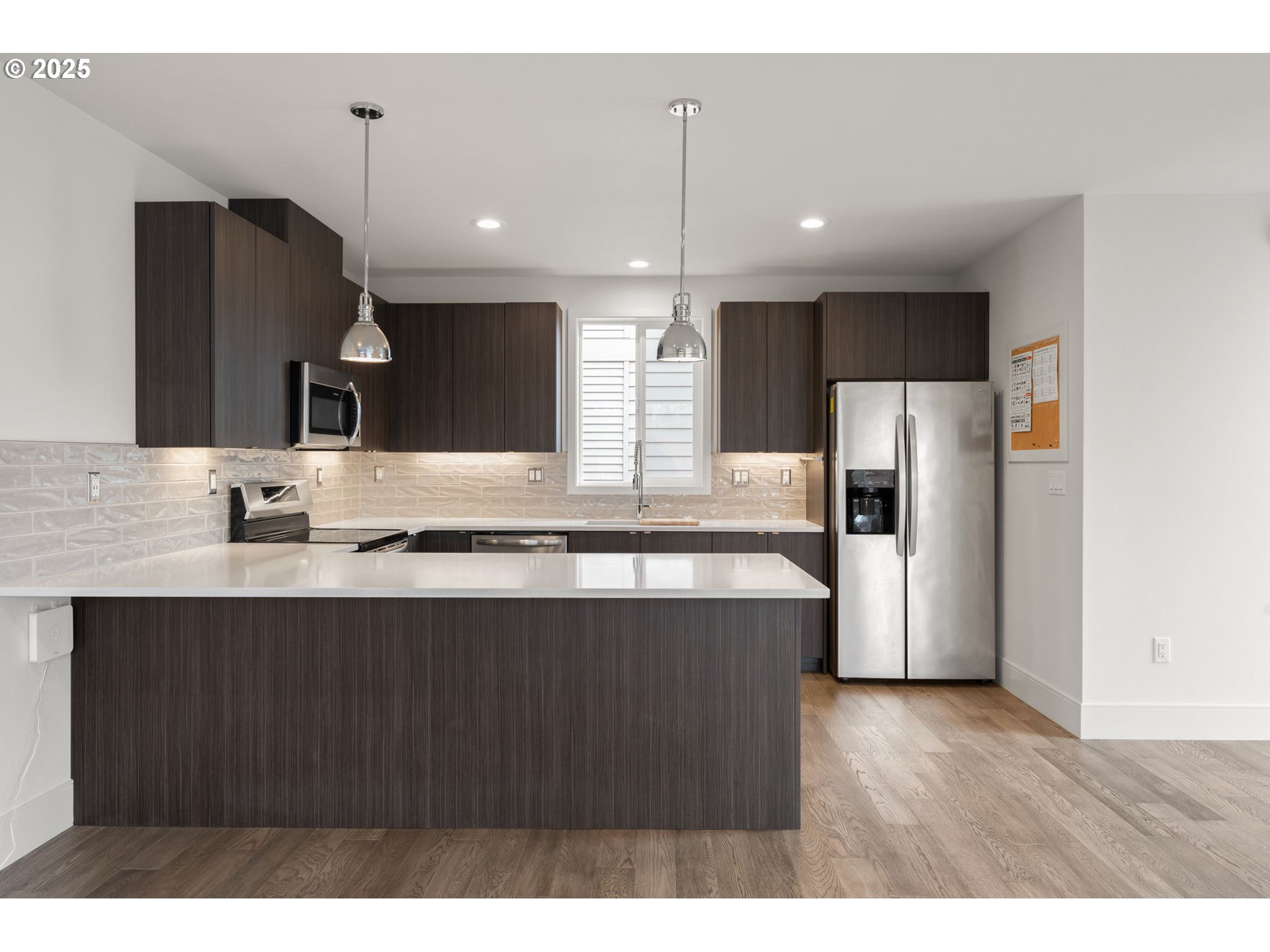 7204 Southeast Steele Street Portland, OR 97206 - Photo 8 of 37 a large kitchen with granite countertop a sink and a refrigerator