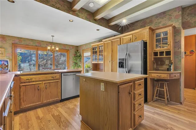 a kitchen with stainless steel appliances granite countertop a stove and a refrigerator