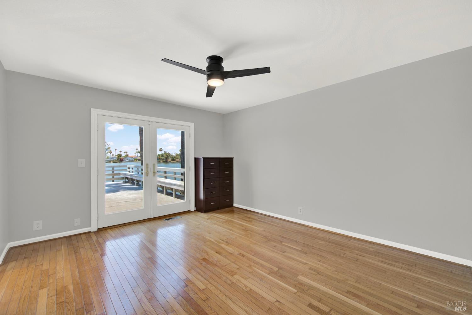 1270 Willow Lake Road Discovery Bay, CA 94505 - Photo 22 of 29 a view of an empty room with wooden floor and a window
