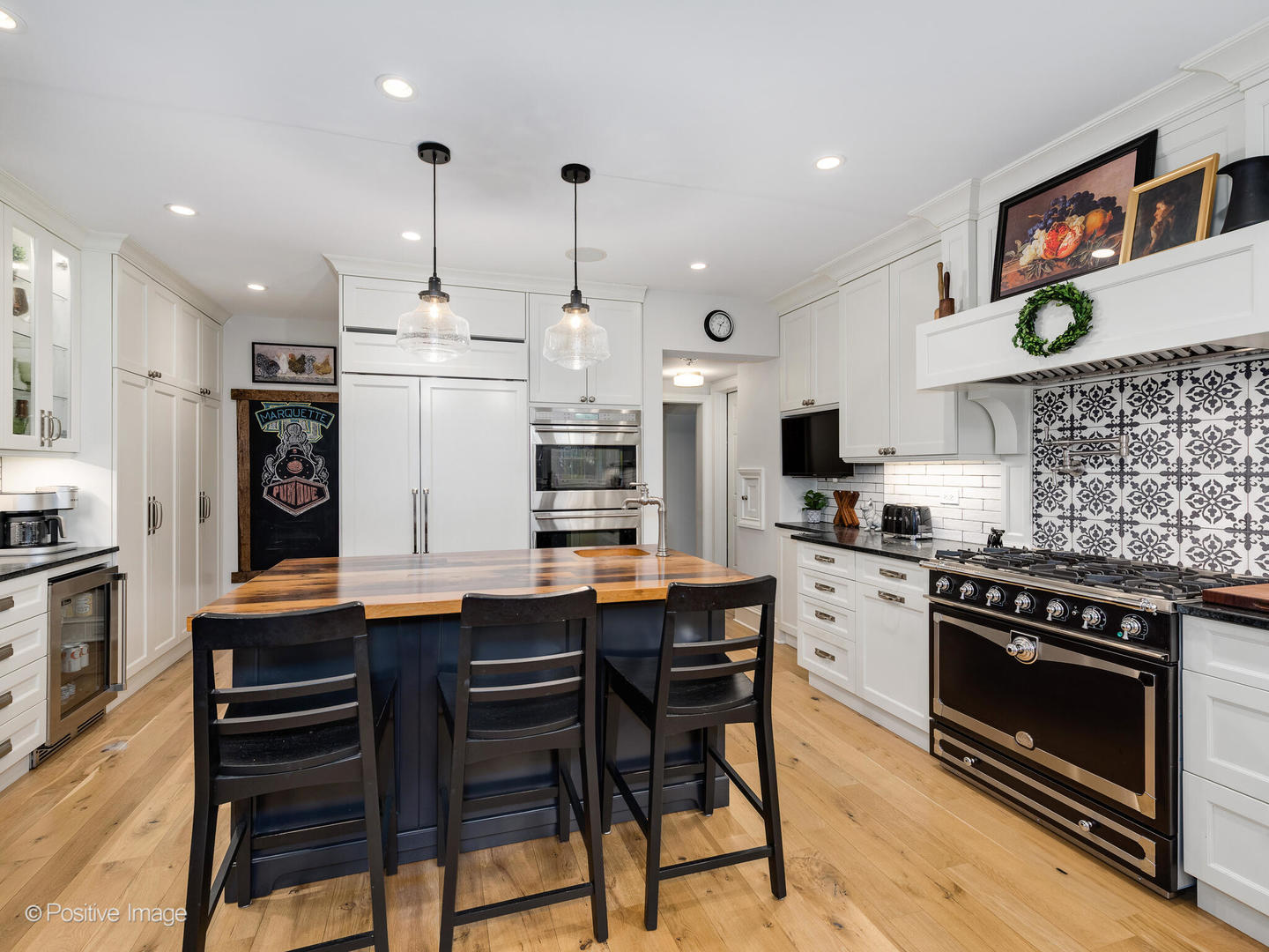 205 Scott Avenue Winnetka, IL 60093 - Photo 9 of 58 a kitchen with stainless steel appliances kitchen island a table and chairs in it