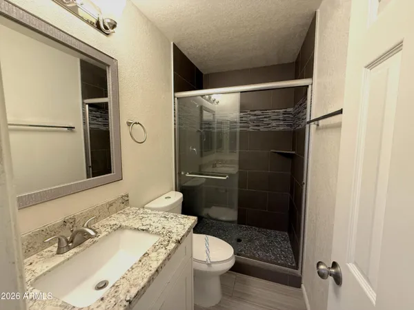 a bathroom with a sink toilet and shower