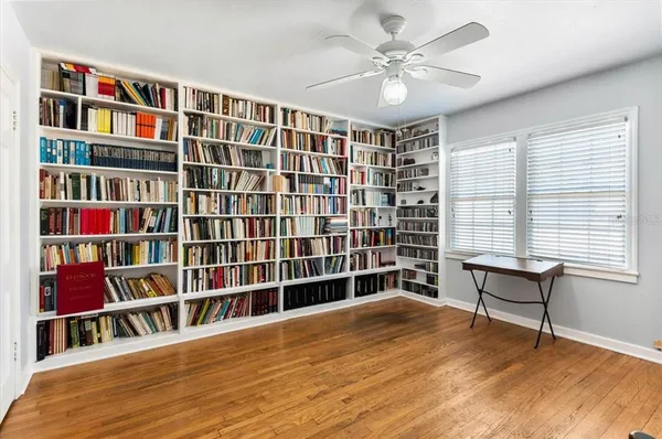 a view of living room with furniture and book shelf