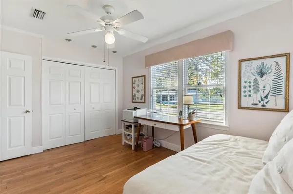 a bedroom with a bed table and a window