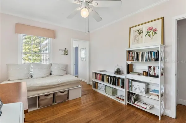 a bedroom with furniture and a book shelf