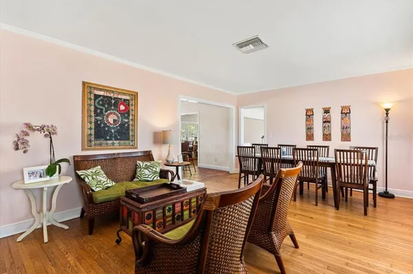 a dining room with furniture wooden floor and a rug