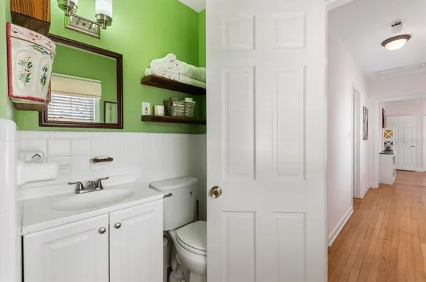 a bathroom with a sink a toilet and mirror
