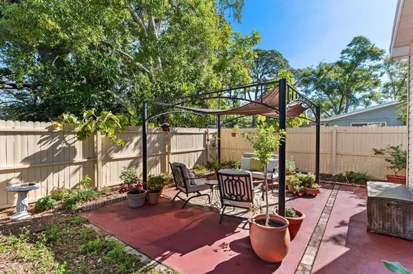 an outdoor space with patio furniture and potted plants