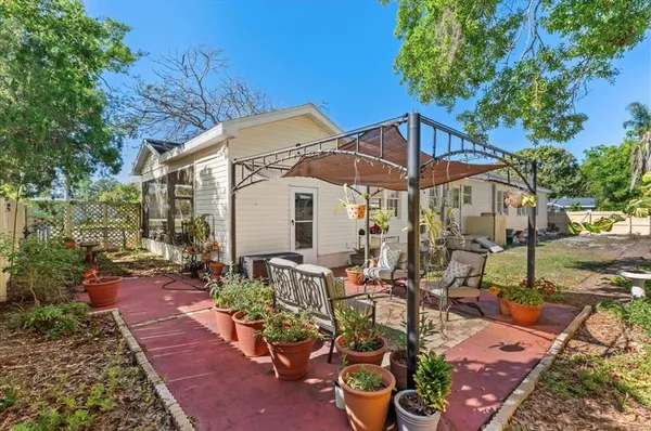 a view of a patio with table and chairs potted plants
