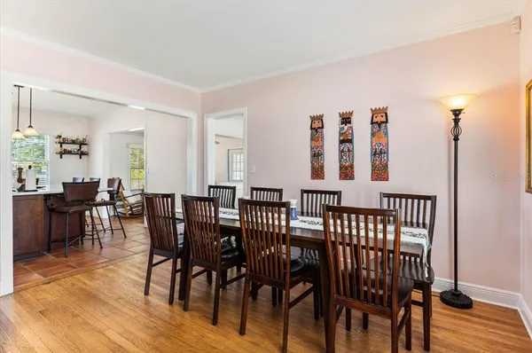 a view of a a dining room with furniture window and wooden floor