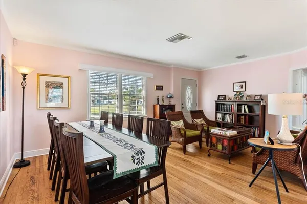 a view of a dining room with furniture window and wooden floor