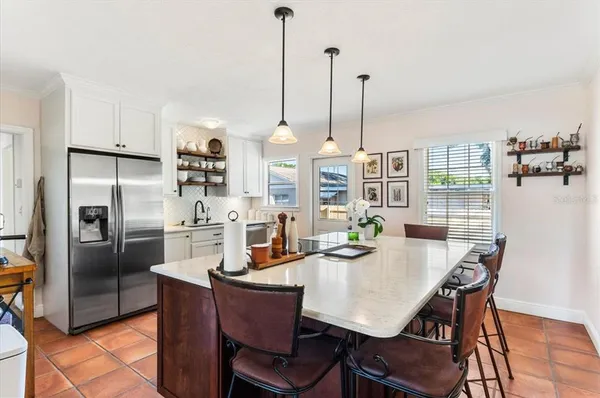 a view of kitchen with dining table and chairs